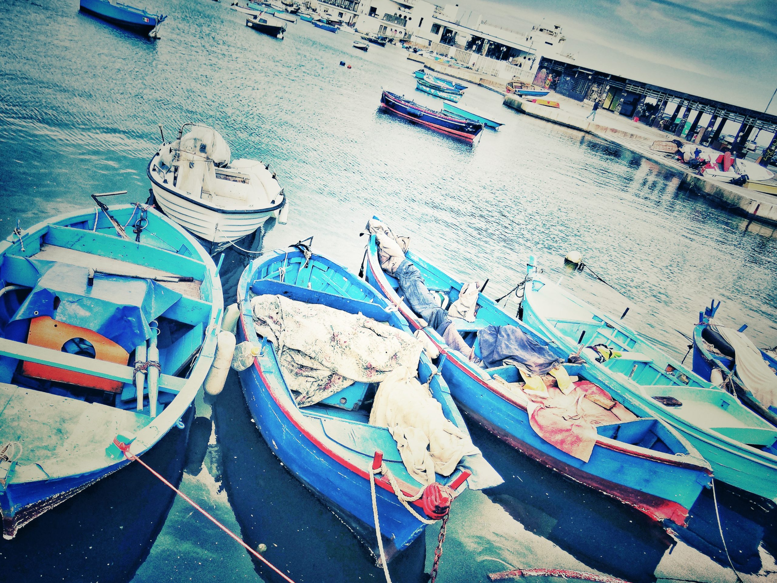 Blue fishing boats at the old port in Bari.